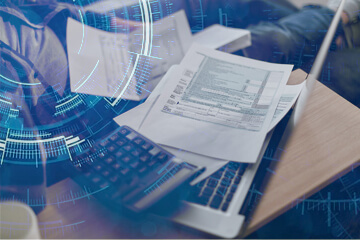 Image of laptop and invoices